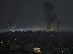 Smoke rises following an Israeli strikes on Gaza City, early Wednesday, May 30, 2018.