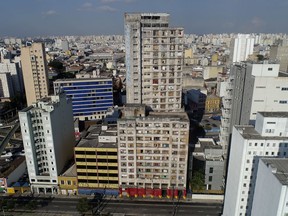 In this May 4, 2018 photo, the Prestes Maia building is occupied by squatters in downtown Sao Paulo, Brazil. Sao Paulo's historic downtown has suffered decades of urban blight, despite the city's status as Latin America's financial capital and home to much of Brazil's wealth.