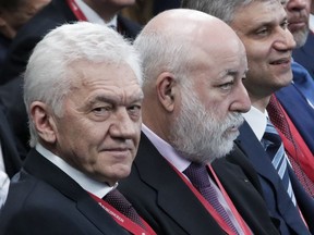 Co-owner of Novatek company Gennady Timchenko, left, and Renova CEO businessman Viktor Vekselberg, second right, attend the St. Petersburg International Economic Forum in St. Petersburg, Russia, Friday, May 25, 2018.