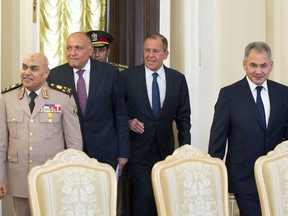 From left, Egyptian Defense Minister Sedki Sobhi, Egyptian Foreign Minister Sameh Shoukry, Russian Foreign Minister Sergey Lavrov and Russian Defense Minister Sergei Shoigu enter a hall for their talks in Moscow, Russia, Monday, May 14, 2018. Russian and Egyptian officials agreed Monday to expand industrial and military cooperation between the two countries.