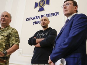 Russian journalist Arkady Babchenko, center, Vasily Gritsak, head of the Ukrainian Security Service, left, and Ukrainian Prosecutor General Yuriy Lutsenko attend a news conference at the Ukrainian Security Service on Wednesday, May 30, 2018. Babchenko turned up at a news conference in the Ukrainian capital Wednesday less than 24 hours after police reported he had been shot and killed at his Kiev apartment building. The country's security services said Babchenko's death was faked to foil a plot to take his life.