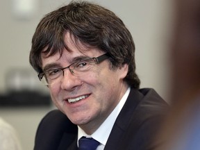 FILE - In this April 18, 2018 file photo, former Catalan leader Carles Puigdemont attends a meeting with lawmakers of his party, Junts per Catalunya (Together for Catalonia), in Berlin, Germany. A German court on Tuesday, May 22, 2018  rejected a request from prosecutors to take former Catalan leader Carles Puigdemont back into custody pending a decision on whether he is extradited to Spain.