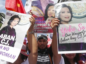 Protesters display portraits of embattled Philippine Supreme Court Chief Justice Maria Lourdes Sereno as they mass in front of the court to rally for Sereno Friday, May 11, 2018 in Manila, Philippines. Hundreds of pro-democracy protesters massed in front of the court to rally for Sereno ahead of an expected vote by fellow justices on a government-backed petition to oust her in a move she calls unconstitutional.