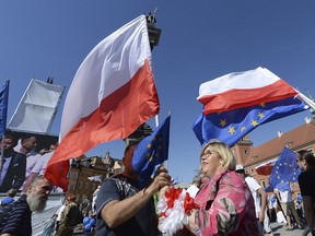 People take part in a demonstration during an anti-government protest, called 'Freedom March' and organized by opposition parties, in Warsaw, Poland, Saturday, May 12, 2018.