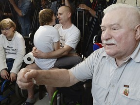 Former Polish president and anti-communist leader Lech Walesa, right, meeting with disabled people and their parents to offer them solidarity on the 34th day of their sit-in at the parliament in demand for more state aid, at the parliament building in Warsaw, Monday, May 21, 2018.