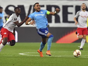 Marseille's Dimitri Payet, center, is pulled by Salzburg's Amadou Haidara during the Europa League second leg semifinal soccer match between Salzburg and Marseille, in Salzburg, Austria, Thursday, May 3, 2018.