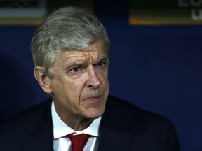 Arsenal manager Arsene Wenger looks out from the bench prior to the Europa League semifinal, second leg soccer match between Atletico Madrid and Arsenal at the Metropolitano stadium in Madrid, Spain, Thursday, May 3, 2018.