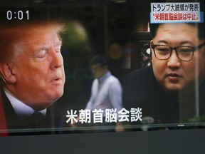 A man is reflected on a TV screen showing North Korean leader Kim Jong Un, right, and U.S. President Donald Trump in Tokyo Friday, May 25, 2018. President Donald Trump on Thursday abruptly canceled his summit with North Korea's Kim Jong Un, blaming "tremendous anger and open hostility" by Pyongyang , a decision North Korea called "regrettable" while still holding out hope for "peace and stability." The Japanese, bottom, read " Summit between U.S. and North Korea."