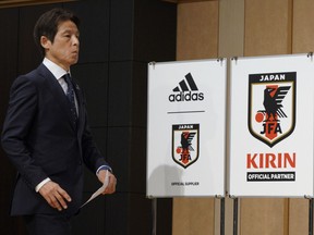 Japanese men's national soccer coach Akira Nishino walks to attend a press conference to announce Japanese squad members for the World Cup Russia in Tokyo, Japan, Thursday, May 31, 2018.