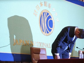 Nihon University's American football player Taisuke Miyagawa bows at a news conference Tuesday, May 22, 2018, in Tokyo. The Japanese college football player has apologized for intentionally injuring the quarterback of an opposing team, an incident that has riveted Japan for several weeks.  In a news conference broadcast live across Japan, Miyagawa bowed deeply and said his coach had told him to do it - but he said he should have been stronger and refused the coaching order.