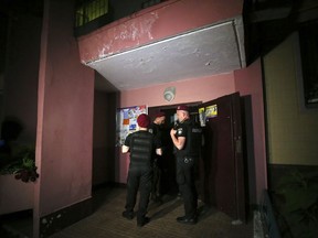 Police guard the front door of the multi-storey building where Russian opposition journalist Arkady Babchenko lived, in Kiev, Ukraine, Tuesday, May 29, 2018. Police in the capital of Ukraine say a Russian journalist has been shot and killed at his Kiev apartment. Ukrainian police said Arkady Babchenko's wife found him bleeding at the apartment on Tuesday and called an ambulance, but Babchenko died on the way to a hospital.