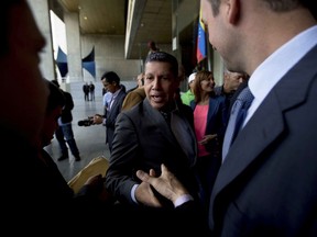 Former presidential candidate Henri Falcon greets members of the press as he arrives to the Supreme Court in Caracas, Venezuela, Wednesday, May 30, 2018. Falcon, who tried to defeat President Nicolas Maduro in Venezuela's contested May 20 presidential election, is filing a formal challenge in the nation's government-stacked supreme court as he refuses to recognize the result of an election he and numerous foreign nations are condemning as a farce.