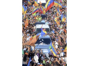 Venezuelan Presidential candidate Henri Falcon, center, greets supporters upon his arrival to a rally in Barquisimeto, Venezuela Thursday, May 17, 2018. Venezuelans will vote for a new president in the upcoming presidential elections on May 20.