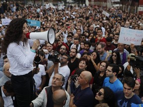 Joumana Haddad, a novelist and candidate running on an independent list, speaks to her supporters during a protest against what they say are clear signs of fraud to deny her victory, outside the Interior Ministry, in Beirut, Lebanon, Monday, May 7, 2018. Haddad's win was thrown in question on Monday, amid news that another candidate had edged her out according to preliminary results. Official results have yet to be announced, 24 hours after polls closed.