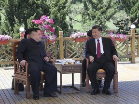 In this photo taken between May 7 and 8, 2018 released by Xinhua News Agency, Chinese President Xi Jinping, right speaks to North Korean leader Kim Jong Un in Dalian in northeastern China's Liaoning Province.