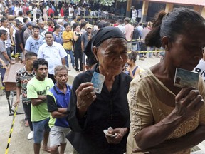 People queue up to give their votes at a polling station in Dili, East Timor, Saturday, May 12, 2018. East Timorese voted in their second election for parliament in less than a year after the collapse of a minority government.