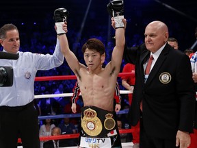 Japanese challenger Naoya Inoue, center, celebrates after winning over British champion Jamie McDonnell during their WBA World bantamweight title match in Tokyo Friday, May 25, 2018.