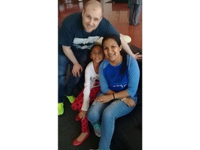 ADDS NAME OF DAUGHTER - In this image provided by the Holt family, Joshua Holt poses for a photo with his wife Thamara and her daughter Marian Leal, at the airport in Caracas, Venezuela, Saturday, May 26, 2018.  Jailed in Venezuela on weapons charges nearly two years ago, Holt was released Saturday after a U.S. senator pressed for his freedom in a surprise meeting with President Nicolas Maduro. Holt and his wife, who also jailed, were reunited with her daughter from a previous relationship at Caracas' airport where the three boarded a chartered flight to Washington.