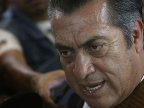 FILE - In this April 16, 2018 file photo, independent presidential candidate Jaime Rodriguez, known as "El Bronco," left, speaks with people as he campaigns at La Lagunilla market in Mexico City. Mexico's electoral institute announced Monday, May 28, 2018, that it has fined Rodriguez more than $37,000 (739,000 pesos) for an assortment of alleged campaign violations.