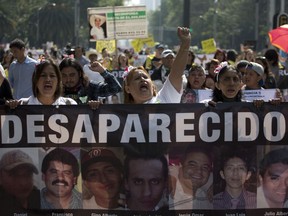 FILE - In this May 10, 2018 file photo, women carry a banner calling attention to the cases of people who have gone missing in the fight against drug cartels and organized crime, demanding authorities locate their loved ones, as they mark Mother's Day in Mexico City. According to federal data, there have been more than 6,000 registered disappearances in Mexico's Tamaulipas state alone since 2006, more than any other state.