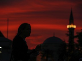 People walk in the historic Sultanahmet district of Istanbul, Wednesday, May 16, 2018 on the first day of the fasting month of Ramadan. Muslims throughout the world are marking Ramadan - a month of fasting during which the observants abstain from food, drink and other pleasures from sunrise to sunset. After an obligatory sunset prayer, a large feast known as 'iftar' is shared with family and friends.
