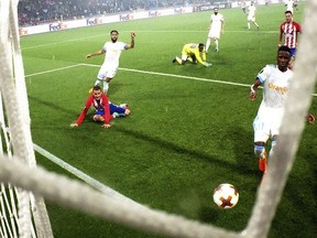 Atletico Madrid's Antoine Griezmann, left, scores his side second goal second goal during the Europa League Final soccer match between Marseille and Atletico Madrid at the Stade de Lyon outside Lyon, France, Wednesday, May 16, 2018.