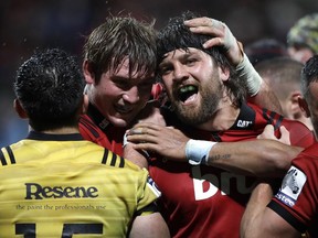 Crusaders Heiden Bedwell-Curtis, right, is congratulated by a teammate after scoring a try against the Hurricanes during their Super Rugby match in Christchurch, New Zealand, Friday, May 25, 2018.