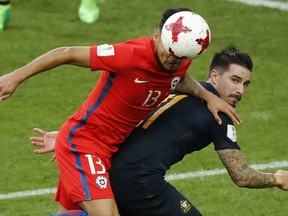 FILE- In this June 25, 2017 file photo, Chile's Paulo Cesar Diaz Huincales, left, challenges for the ball with Australia's Jamie Maclaren, right, during the Confederations Cup, Group B soccer match between Chile and Australia, at the Spartak Stadium in Moscow. Striker Jamie Maclaren has been recalled to Australia's preliminary World Cup squad because of concerns over the fitness of Tomi Juric.