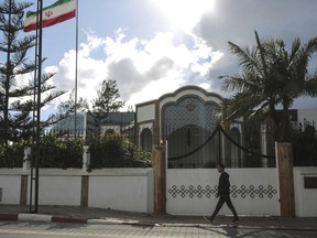 A man walks past the embassy of Iran in Rabat, Morocco, Tuesday, May 1, 2018. Morocco will sever diplomatic ties with Iran over Tehran's support for the Polisario Front, a Western Sahara independence movement, the Moroccan foreign minister said on Tuesday.
