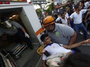 A man who was shot and wounded is loaded into an ambulance during clashes at a march against Nicaragua's President Daniel Ortega in Managua, Nicaragua, Wednesday, May, 30, 2018. Violence returned to protests against Nicaraguan President Daniel Ortega's government when riot police and government supporters confronted protesters during a mother's day march to commemorate those mothers who has lost their children during the ongoing protests.