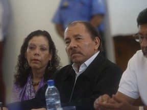 Nicaragua's President Daniel Ortega and Vice President and first lady Rosario Murillo attend the opening of a national dialogue, in Managua, Nicaragua, Wednesday, May 16, 2018. Ortega sat down Wednesday to formally talk with opposition and civic groups for the first time since he returned to power in 2007. The dialogue comes after more than 60 people died amid a government crackdown on demonstrations against social security cuts.