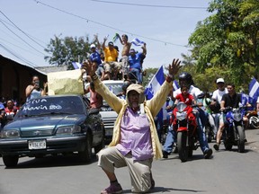 A senior gets down on one knee, as a symbol of peace, amid anti-government protesters arriving in a caravan to show solidarity with the town of Masaya, Nicaragua, Sunday, May 13, 2018. Protesters traveled to the town to show support after heavy overnight clashes between anti-government demonstrators with police and government supporters. According to Nicaragua's Human Rights Protection Association, two people died and at least 100 were injured during the violence.