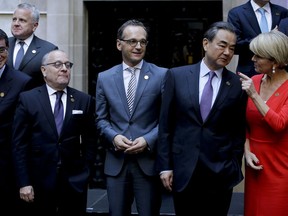 Argentina's Foreign Secretary Jorge Faurie, second from left, Germany's Foreign Minister Heiko Maas, third from left, China's Foreign Minister Wang Yi, second from right, and Australia's Foreign Affairs Minister Julie Bishop talk before the group picture during the G20 foreign ministers meeting at San Martin Palace in Buenos Aires, Argentina, Monday, May 21, 2018.
