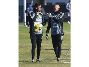 Argentina goalkeeper Sergio Romero talks to teammate Wilfredo Caballero as they attend a training session of the Argentina national soccer team in Buenos Aires, Argentina, Tuesday, May 22, 2018. The Argentine Football Association announced that goalkeeper Sergio Romero will not be able to play in the World Cup due to a knee injury.