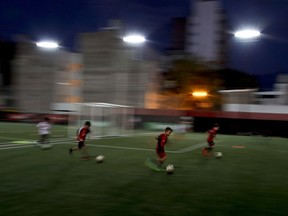 In this April 17, 2018 photo, children train at the Newell's Old Boys youth training headquarters in Rosario, Argentina, the hometown of soccer great Lionel Messi. Messi was born a year after Maradona led Argentina to the World Cup trophy in 1986, and has faced comparisons to the former Argentine captain throughout his life, even when they could not be more different off the field.