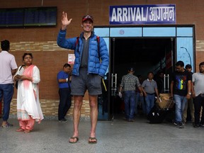 Australian climber Steve Plain waves as he arrives in Kathmandu airport, Nepal, Saturday, May 19, 2018. Plain earlier this week scaled the 8,850-meter (29,035-foot) Mount Everest completing his mission to scale all the highest peaks in the seven continents in 117 days. Polish climber Janusz Kochanski held the previous record for climbing the seven peaks, doing it in 126 days last year.