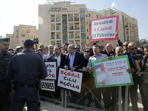 Israeli Arab Knesset members and left wing activists participate in protest against the opening of the new US embassy in Jerusalem, during the embassy's official inauguration ceremony, Monday, May 14, 2018. Amid deadly clashes along the Israeli-Palestinian border, President Donald Trump's top aides and supporters on Monday celebrated the opening of the new U.S. Embassy in Jerusalem as a campaign promised fulfilled.