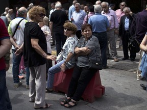 Pensioners take part in a protest outside the Labor ministry in central Athens, on Wednesday, May 16, 2018. The government has repeatedly cut pensions as part of the country's three international bailouts. More cuts are planned in 2019.