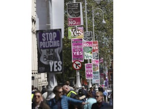 In this May 17, 2018 photo, pro and anti-abortion posters are displayed on lampposts outside government buildings in Dublin, Ireland, ahead of the abortion referendum on Friday, May 25. An abortion debate that has inflamed passions in Ireland for decades will come down to a single question on Friday: yes or no? The referendum on whether to repeal the country's strict anti-abortion law is being seen by anti-abortion activists as a last-ditch stand against what they view as a European norm of abortion-on-demand, while for pro-abortion rights advocates, it is a fundamental moment for declaring an Irish woman's right to choose.