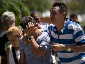 Grieving relatives of passengers who perished in Cuba's worst aviation disaster arrive to the morgue, in Havana, Cuba, Saturday, May 19, 2018. Investigators are trying to determine why an aging Boeing 737 carrying more than 100 people went down and erupted in flames shortly after takeoff in Havana.