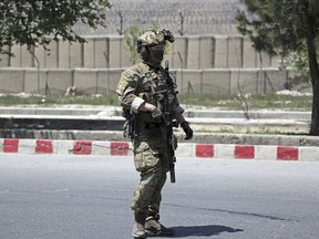 A U.S. soldier arrives at the site of deadly attack on the interior ministry, in Kabul, Afghanistan, Wednesday, May 30, 2018. Afghan officials said a suicide bomber struck outside the ministry, allowing gunmen to pass through an outer gate where they traded fire with security forces, who eventually killed the attackers.