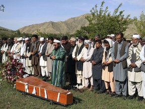 Relatives, colleagues and friends offer funeral prayers behind the body of AFP chief photographer, Shah Marai, who was killed in today's second suicide attack, in Guldara, a district of Kabul province, Afghanistan, Monday, April 30, 2018. A coordinated double suicide bombing by the Islamic State group in central Kabul has killed at least 25 people, including several Afghan journalists.