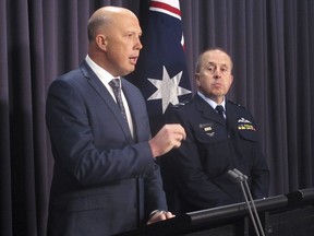 Australian Border Protection Minister Peter Dutton, left, and Air Vice-Marshal Stephen Osborne, commander of Operation Sovereign Borders, address reporters at Parliament House in Canberra, Australia, Monday, May 7, 2018. Dutton says people smugglers are now marketing New Zealand as a backdoor into Australia.