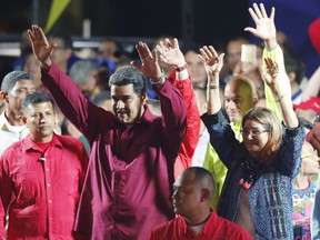 Venezuela's President Nicolas Maduro and his wife Cilia Flores wave to supporters at the presidential palace in Caracas, Venezuela, Sunday, May 20, 2018. Electoral officials declared the socialist leader the winner of Sunday's presidential election, while his leading challenger questioned the legitimacy of a vote marred by irregularities and called for a new ballot to prevent a brewing social crisis from exploding.