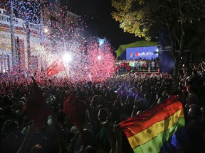 Supporters of Venezuela's President Nicolas Maduro gather at the presidential palace in Caracas, Venezuela, Sunday, May 20, 2018. Electoral officials declared the socialist leader the winner of Sunday's presidential election, while his leading challenger questioned the legitimacy of a vote marred by irregularities and called for a new ballot.