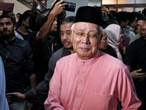 In this Friday, May 11, 2018, photo, Malaysia's former Prime Minister Najib Razak attends an event of the United Malays National Organization's 72nd anniversary in Kuala Lumpur, Malaysia. Najib says he will take a short holiday to spend time with his family after a shocking electoral defeat that ended the 60-year rule of his coalition. A leaked flight manifesto shows Najib and his wife Rosmah Mansor are due to leave on a private jet on Saturday, May 12, 2018 to Jakarta, fueling rumors he was fleeing the country to escape possible prosecution over a massive corruption scandal involving the 1MDB state fund.