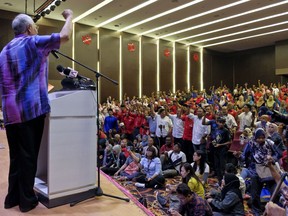 Former Malaysian Prime Minister Najib Razak chants with his supporters during his speech at the United Malays National Organization (UMNO) building in Pekan, Malaysia, Sunday, May 20, 2018. Former Malaysian Prime Minister Najib Razak says he is aggrieved with his coalition's shocking election defeat because it was due to a vicious personal attack against him.