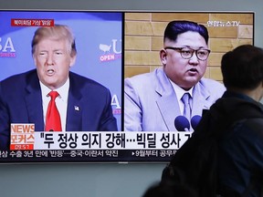 FILE - In this May 11, 2018, file photo, a man watches a TV screen showing file footage of U.S. President Donald Trump, left, and North Korean leader Kim Jong Un with onscreen letters reading "Summit between U.S. and North Korea, Forecast, Clear." during a news program at the Seoul Railway Station in Seoul, South Korea.  North Korea's Foreign Ministry said Saturday May 12, 2018, it will hold a "ceremony" for the dismantling of its nuclear test site on May 23-25 in what would be a dramatic but symbolic event to set up the summit meeting between Kim Jong Un and US President Donald Trump scheduled for next month.