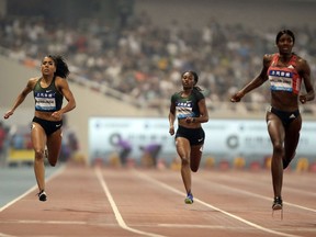 Mujinga Kambundji of Switzerland, left, Kyra Jefferson of the United States, center, and Shaunae Miller-Uibo of the Bahamas, right, compete during the women's 200 meters at the Shanghai Diamond League track and field competition in Shanghai, China, Saturday, May 12, 2018. (AP Photo)