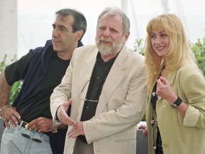 FILE- In this May 15, 1996 file photo, Romanian director Lucian Pintilie, center, poses with actors Razvan Vasilescu, left, and Cecilia Barbora before the presentation of his movie "Too Late" at the 49th International Cannes Film Festival. Romanian director and filmmaker Lucian Pintilie who emigrated after falling out with the communists and then made a career in France and the U.S. has died, aged 84.